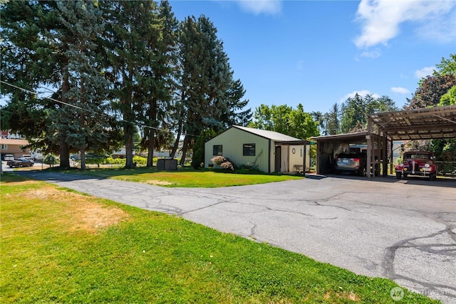 2434 NW Alan Ave, East Wenatchee, WA 98802 - view of side of home featuring a yard, asphalt driveway, and a carport