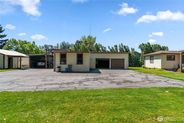2434 NW Alan Ave, East Wenatchee, WA 98802 - view of front of home featuring a front yard, an outdoor structure, a garage, and a carport