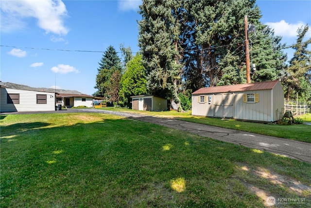 2434 NW Alan Ave, East Wenatchee, WA 98802 - view of grassy yard with a storage shed and driveway