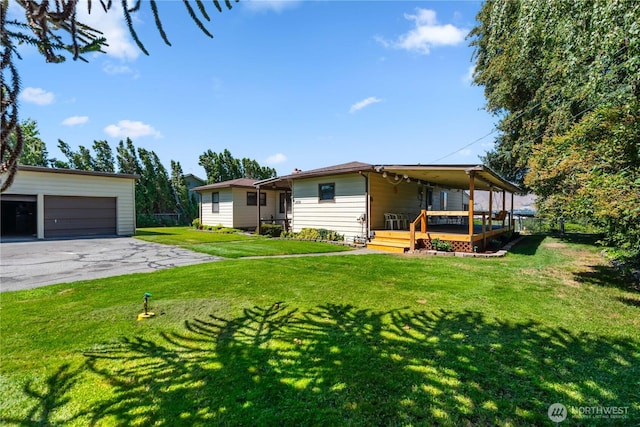 2434 NW Alan Ave, East Wenatchee, WA 98802 - rear view of property featuring an outdoor structure, a yard, a deck, and a detached garage