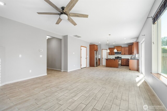 502 182nd St E, Spanaway, WA 98387 - unfurnished living room with a ceiling fan, light wood-style flooring, and recessed lighting