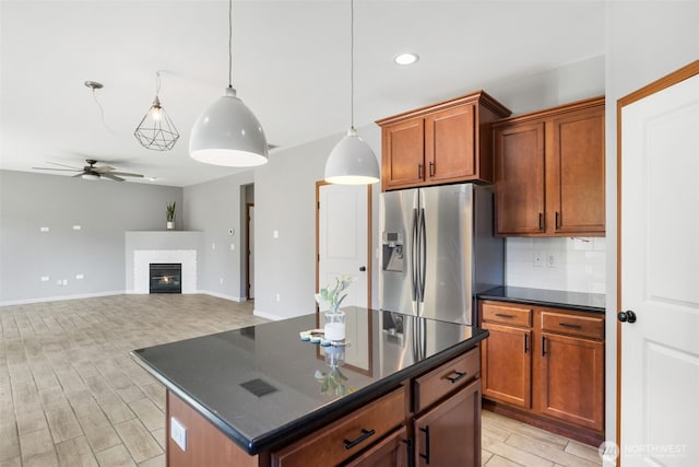 502 182nd St E, Spanaway, WA 98387 - kitchen featuring stainless steel refrigerator with ice dispenser, dark countertops, a ceiling fan, backsplash, and recessed lighting