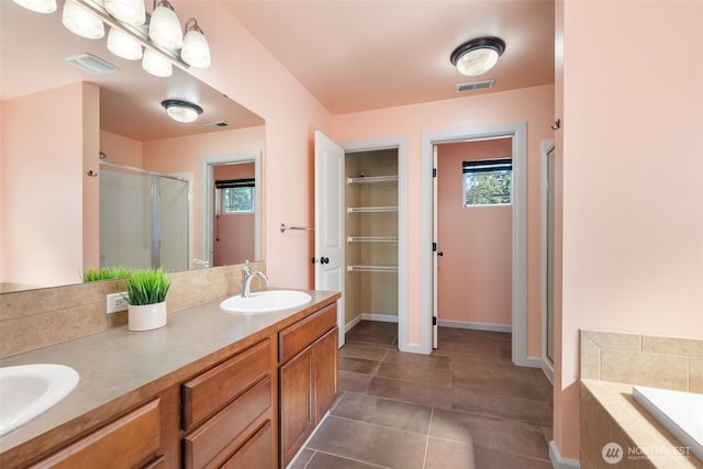 502 182nd St E, Spanaway, WA 98387 - full bath featuring a stall shower, healthy amount of natural light, a garden tub, and double vanity