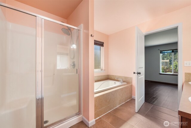 502 182nd St E, Spanaway, WA 98387 - full bathroom with a shower stall, vanity, a garden tub, and tile patterned floors