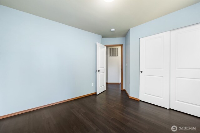 502 182nd St E, Spanaway, WA 98387 - unfurnished bedroom with dark wood-style flooring and a closet