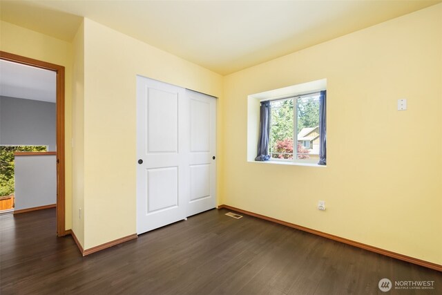 502 182nd St E, Spanaway, WA 98387 - unfurnished bedroom featuring dark wood-type flooring and a closet