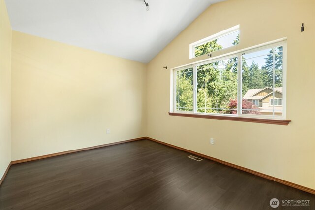 502 182nd St E, Spanaway, WA 98387 - spare room featuring dark wood finished floors and vaulted ceiling