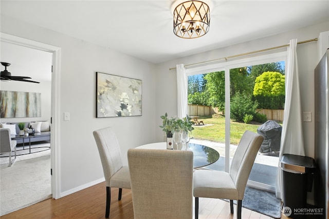 18844 SE 214th St, Renton, WA 98058 - dining room with wood finished floors, a chandelier, and ceiling fan
