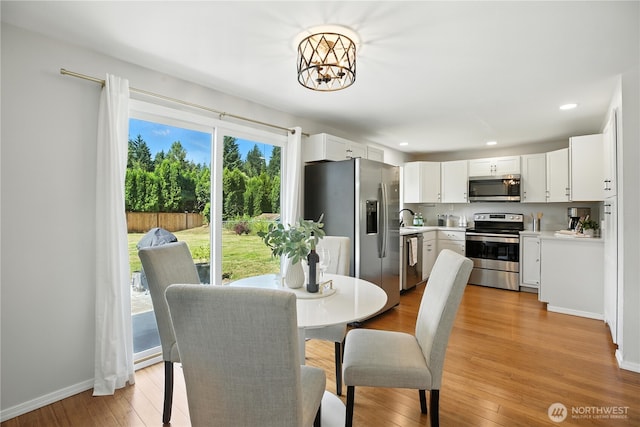 18844 SE 214th St, Renton, WA 98058 - dining room featuring a chandelier, light wood-style floors, and recessed lighting