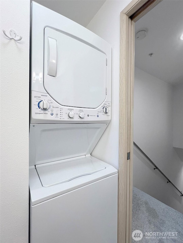 17218 97th Pl SW Unit 303, Vashon, WA 98070 - washroom with stacked washing machine and dryer and carpet