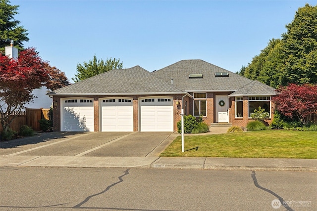 4101 Banbridge Loop SE, Olympia, WA 98501 - view of front of house featuring a garage, brick siding, driveway, and roof with shingles