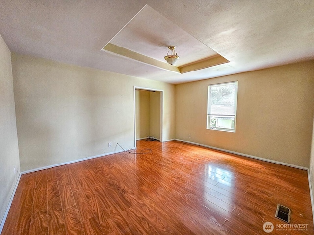 1402 W Market St, Aberdeen, WA 98520 - unfurnished room featuring wood finished floors and a raised ceiling