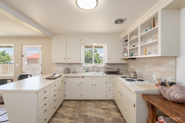 118 N Hemlock St, Soap Lake, WA 98851 - kitchen featuring a peninsula, decorative backsplash, light countertops, white cabinetry, and white electric cooktop