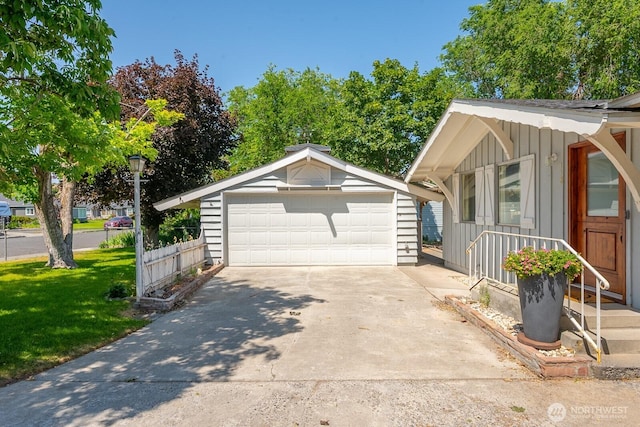 118 N Hemlock St, Soap Lake, WA 98851 - view of property exterior with board and batten siding, an outbuilding, a detached garage, and a lawn