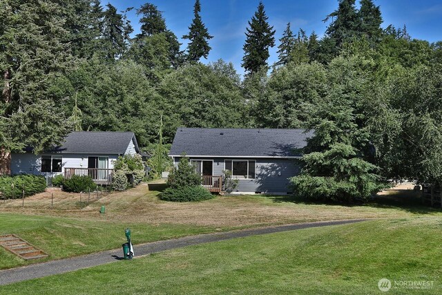 4896 Spinnaker Dr, Freeland, WA 98249 - view of front of house featuring a wooden deck and a front yard