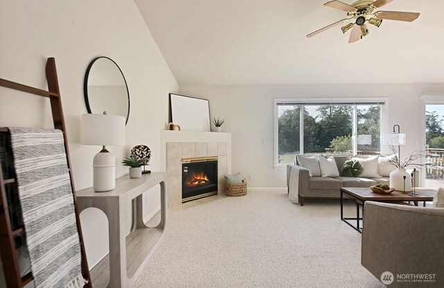 4896 Spinnaker Dr, Freeland, WA 98249 - carpeted living room with vaulted ceiling, a fireplace, and a ceiling fan