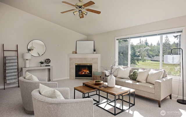 4896 Spinnaker Dr, Freeland, WA 98249 - living area featuring vaulted ceiling, light colored carpet, a ceiling fan, and a tiled fireplace
