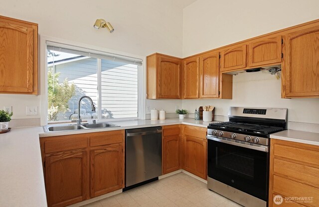 4896 Spinnaker Dr, Freeland, WA 98249 - kitchen featuring appliances with stainless steel finishes, light countertops, and brown cabinets
