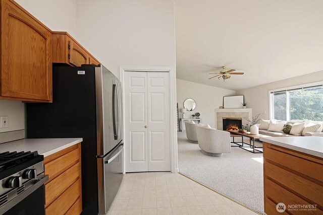 4896 Spinnaker Dr, Freeland, WA 98249 - kitchen featuring a ceiling fan, light countertops, brown cabinets, stainless steel appliances, and open floor plan