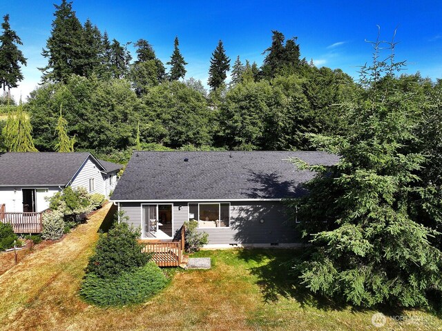 4896 Spinnaker Dr, Freeland, WA 98249 - rear view of house with a deck and a lawn