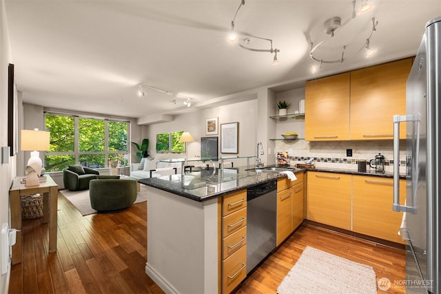 1420 E Pine St Unit E203, Seattle, WA 98122 - kitchen featuring appliances with stainless steel finishes, open floor plan, wood finished floors, and rail lighting