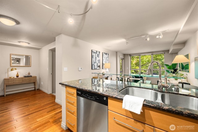 1420 E Pine St Unit E203, Seattle, WA 98122 - kitchen with stainless steel dishwasher, track lighting, light wood finished floors, and dark stone countertops