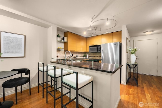 1420 E Pine St Unit E203, Seattle, WA 98122 - kitchen featuring open shelves, freestanding refrigerator, a peninsula, and light wood-style flooring