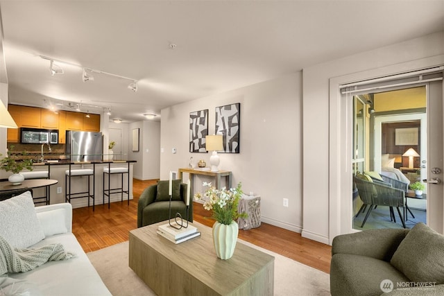 1420 E Pine St Unit E203, Seattle, WA 98122 - living room featuring light wood finished floors and track lighting