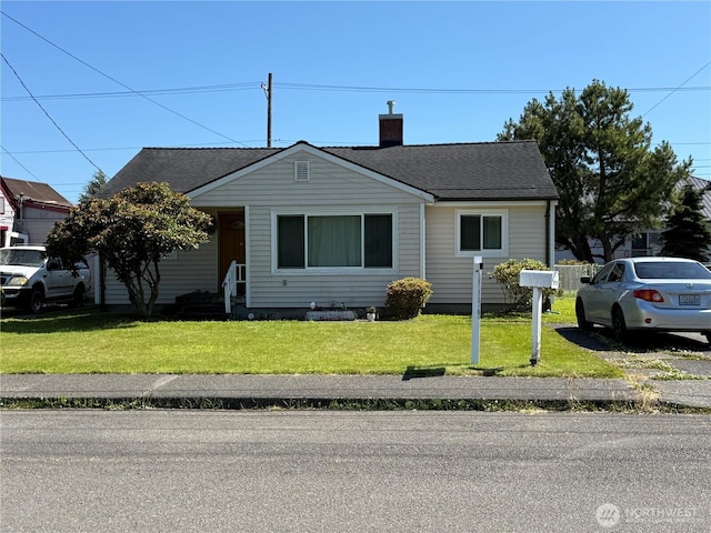 1717 Cherry St, Aberdeen, WA 98520 - bungalow-style house with a chimney, a front yard, and a shingled roof