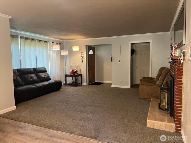 1717 Cherry St, Aberdeen, WA 98520 - living room featuring ornamental molding, a brick fireplace, and carpet floors
