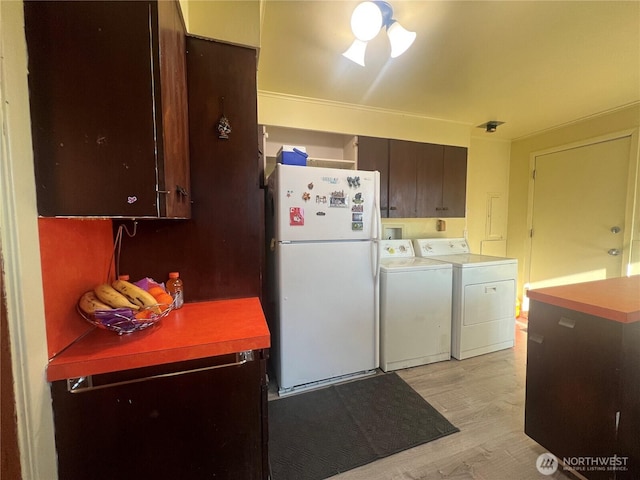 1717 Cherry St, Aberdeen, WA 98520 - kitchen featuring freestanding refrigerator, independent washer and dryer, light wood-type flooring, and dark brown cabinetry
