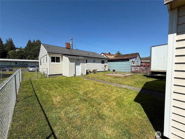 1717 Cherry St, Aberdeen, WA 98520 - rear view of house featuring a fenced backyard and an outdoor structure