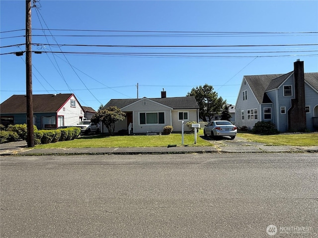 1717 Cherry St, Aberdeen, WA 98520 - bungalow featuring a front lawn and a chimney