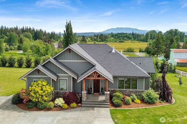 5754 W 26th Crst, Ferndale, WA 98248 - craftsman-style house with board and batten siding, a front yard, a mountain view, and stone siding