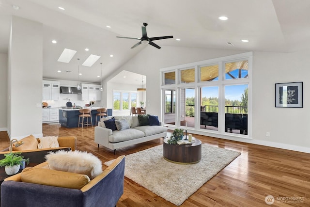 5754 W 26th Crst, Ferndale, WA 98248 - living area featuring a skylight, high vaulted ceiling, recessed lighting, ceiling fan, and light wood-type flooring