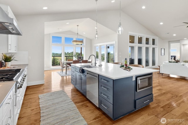5754 W 26th Crst, Ferndale, WA 98248 - kitchen featuring appliances with stainless steel finishes, ventilation hood, high vaulted ceiling, white cabinets, and open floor plan