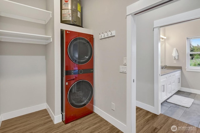 5754 W 26th Crst, Ferndale, WA 98248 - laundry room featuring stacked washer / dryer and wood finished floors