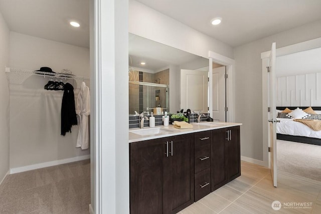 821 SE 12th Pl Unit 31, North Bend, WA 98045 - full bath with double vanity, a shower stall, a spacious closet, connected bathroom, and recessed lighting