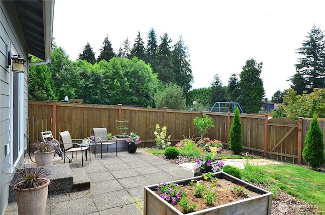 27719 NE 146th Way, Duvall, WA 98019 - fenced backyard with a patio area and a vegetable garden