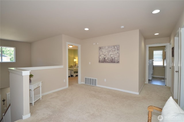 27719 NE 146th Way, Duvall, WA 98019 - unfurnished living room with light colored carpet, recessed lighting, and washer / dryer