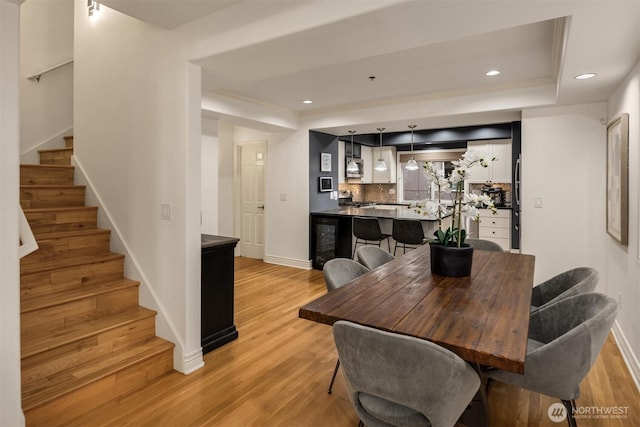 1416 6th Ave N, Seattle, WA 98109 - dining room featuring stairs, light wood-style flooring, a raised ceiling, and recessed lighting