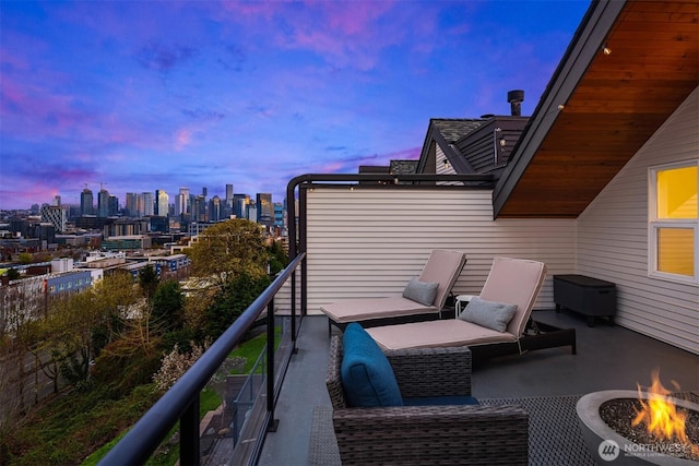 1416 6th Ave N, Seattle, WA 98109 - balcony at dusk featuring an outdoor fire pit and a view of skyline