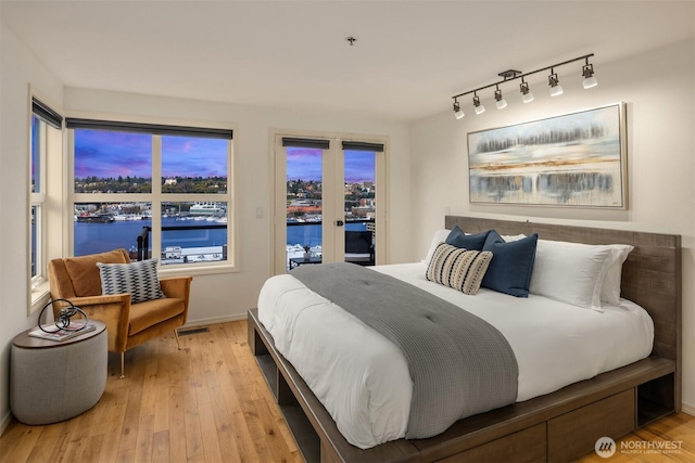 1416 6th Ave N, Seattle, WA 98109 - bedroom with access to exterior, light wood-type flooring, and rail lighting