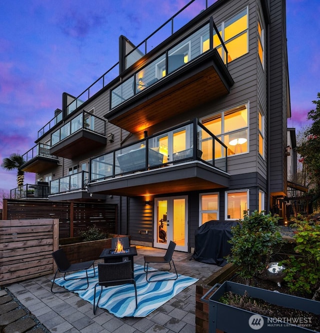 1416 6th Ave N, Seattle, WA 98109 - back of property with an outdoor fire pit, a balcony, and a patio