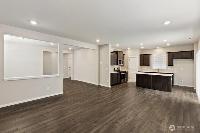 28303 74th Dr NW Unit 88, Stanwood, WA 98292 - kitchen with appliances with stainless steel finishes, open floor plan, dark wood finished floors, dark brown cabinets, and recessed lighting
