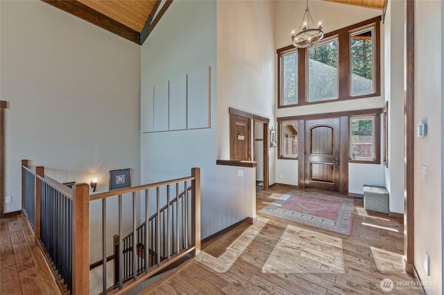 239 Foxridge Ln, Leavenworth, WA 98826 - entryway with high vaulted ceiling, wood-type flooring, a chandelier, and a wooden ceiling with exposed beams