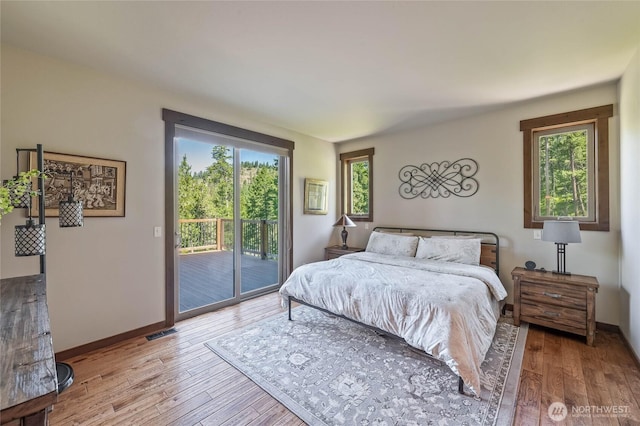 239 Foxridge Ln, Leavenworth, WA 98826 - bedroom featuring access to exterior, wood finished floors, and multiple windows