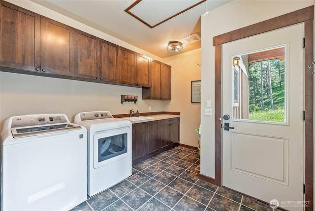 239 Foxridge Ln, Leavenworth, WA 98826 - laundry room featuring cabinet space, washing machine and dryer, and dark tile patterned flooring