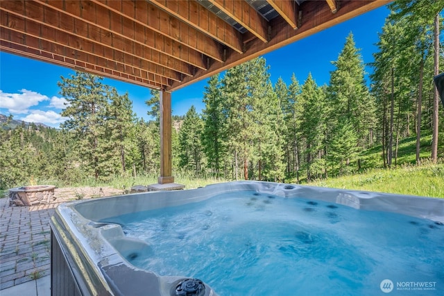 239 Foxridge Ln, Leavenworth, WA 98826 - view of patio / terrace with a hot tub and a wooded view
