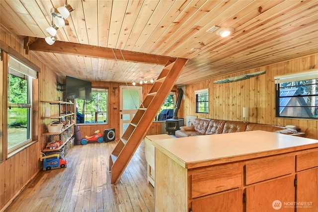 13990 Brae Burn Rd, Leavenworth, WA 98826 - kitchen with wooden ceiling, wooden walls, a wood stove, light wood-type flooring, and open floor plan